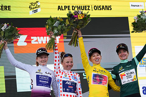Tour de France Women cycling race: Katarzyna Niewiadoma, wearing the overall leader's yellow jersey, Marianne Vos, wearing the best sprinter's green jersey, Justine Ghekiere, wearing the best climber's dotted jersey, and Puck Pieterse, wearing the best young rider's white jersey celebrate on the podium after the eighth stage